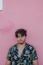 Young Bearded Man in Floral Shirt Standing in Front of Pink Wall
