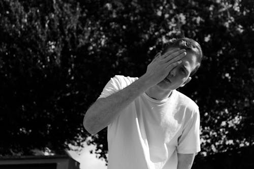 Grayscale Photo of Man Wearing White Crew-neck Shrit