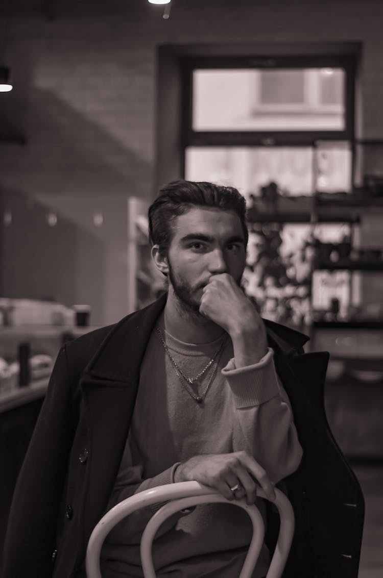 Sepia Toned Image Of A Man Posing On A Chair