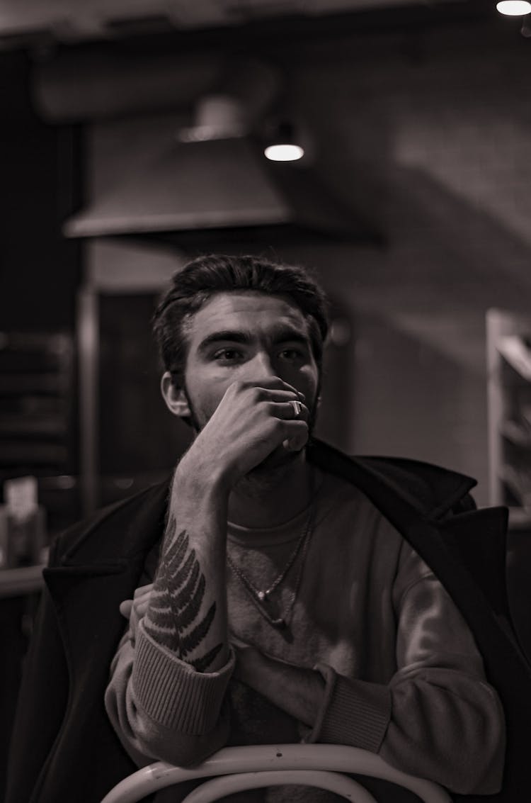 Sepia Toned Photo Of A Man With Fern Tattoo