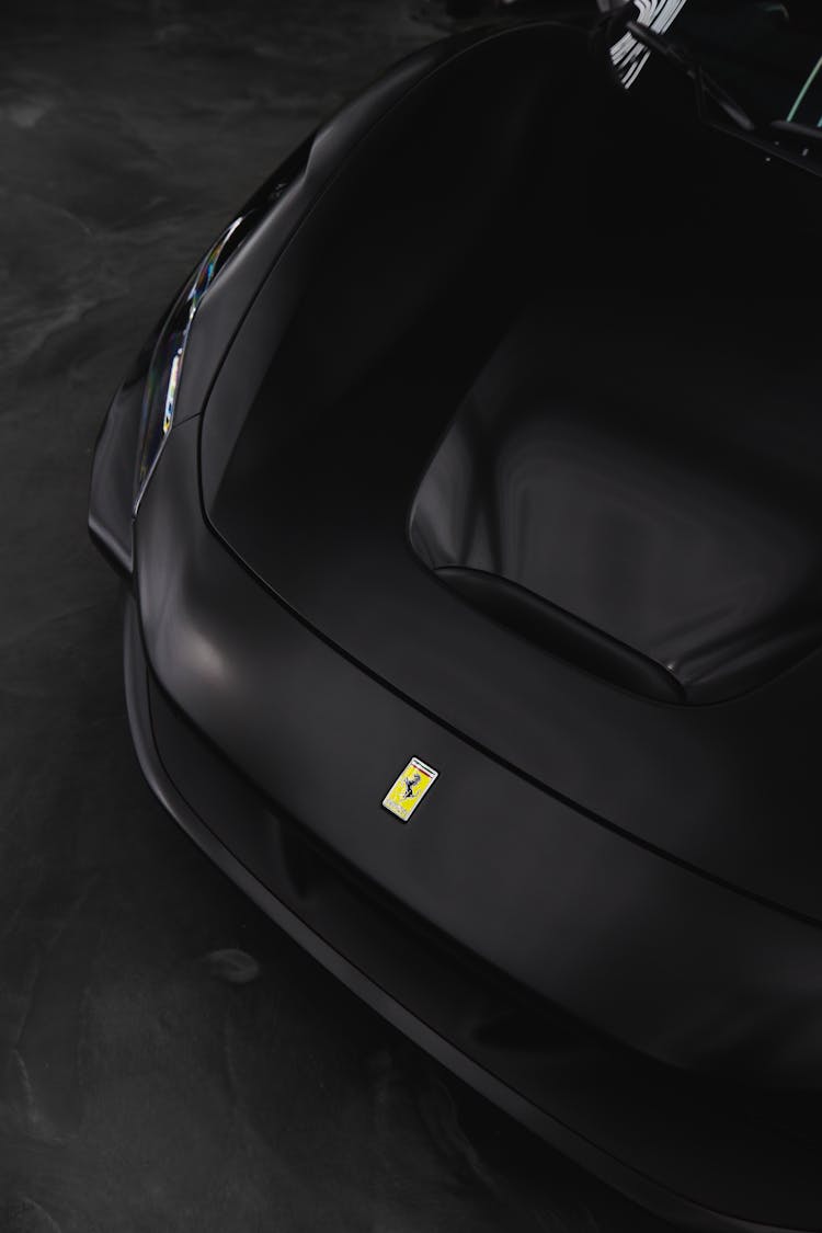 Black Ferrari Car On Gray Pavement