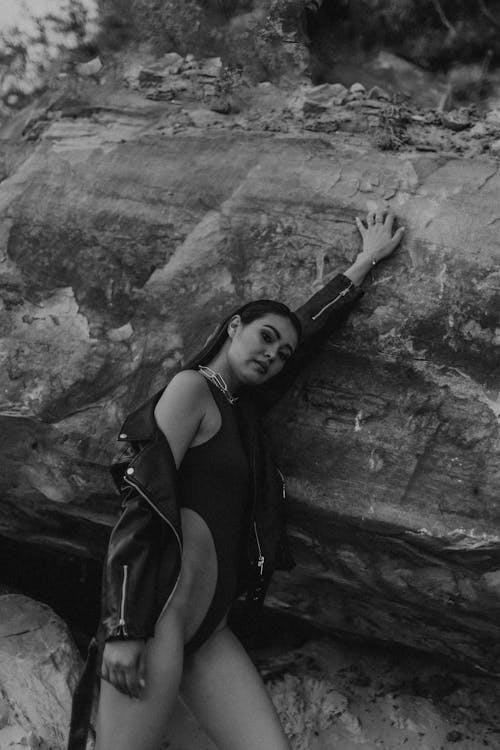Woman in Bikini Wearing Leather Jacket Posing on Rock 