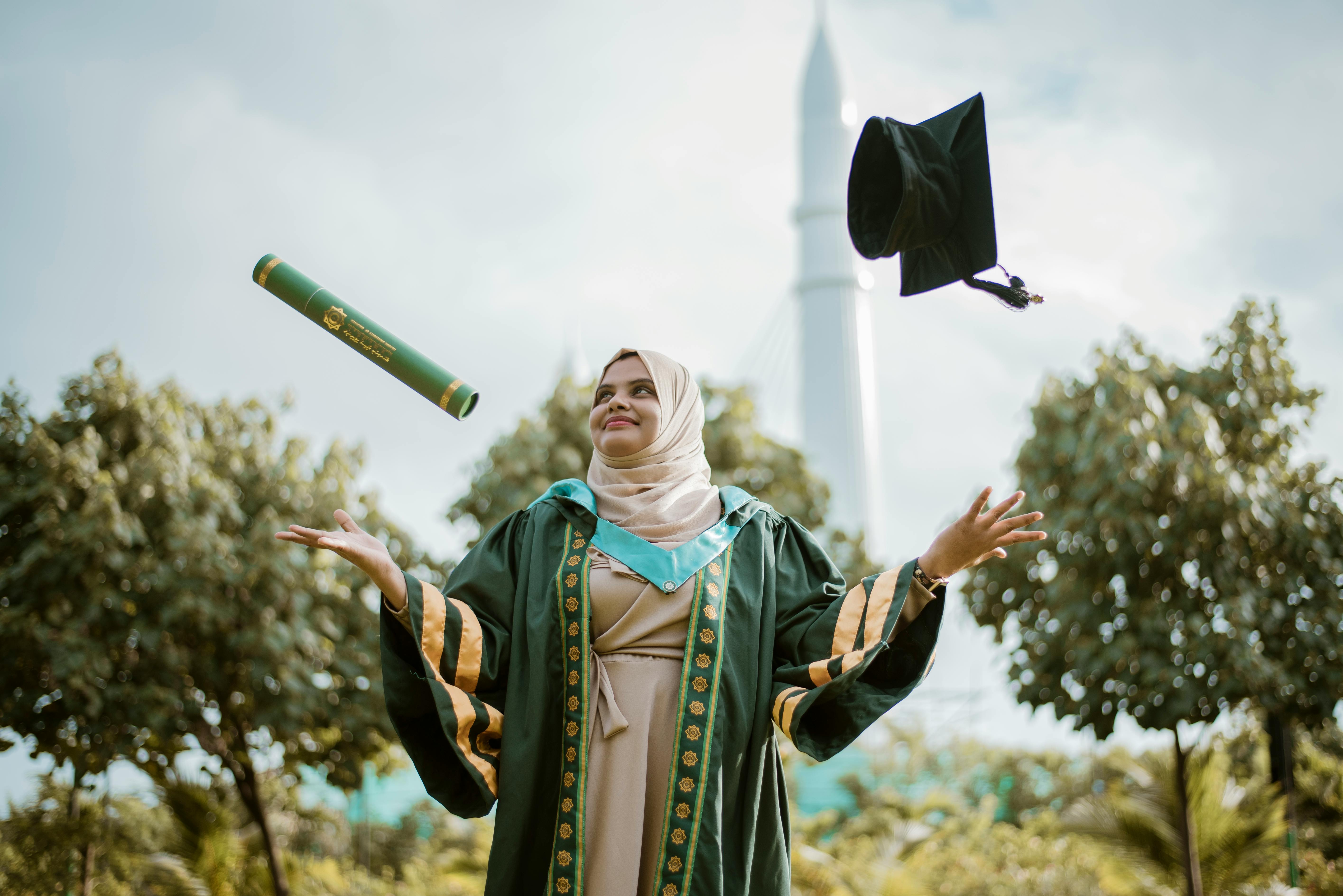 academic hat and diploma flying around woman in gown