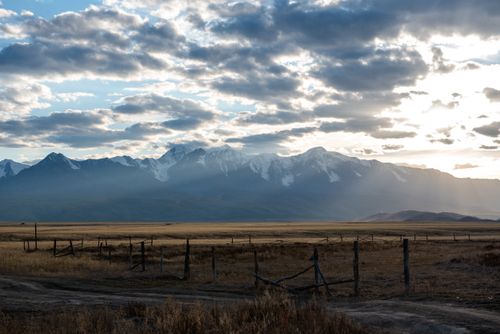 Free Beautiful Altai mountain landscape with sunlight breaking through clouds at sunrise, capturing the serene natural beauty. Stock Photo