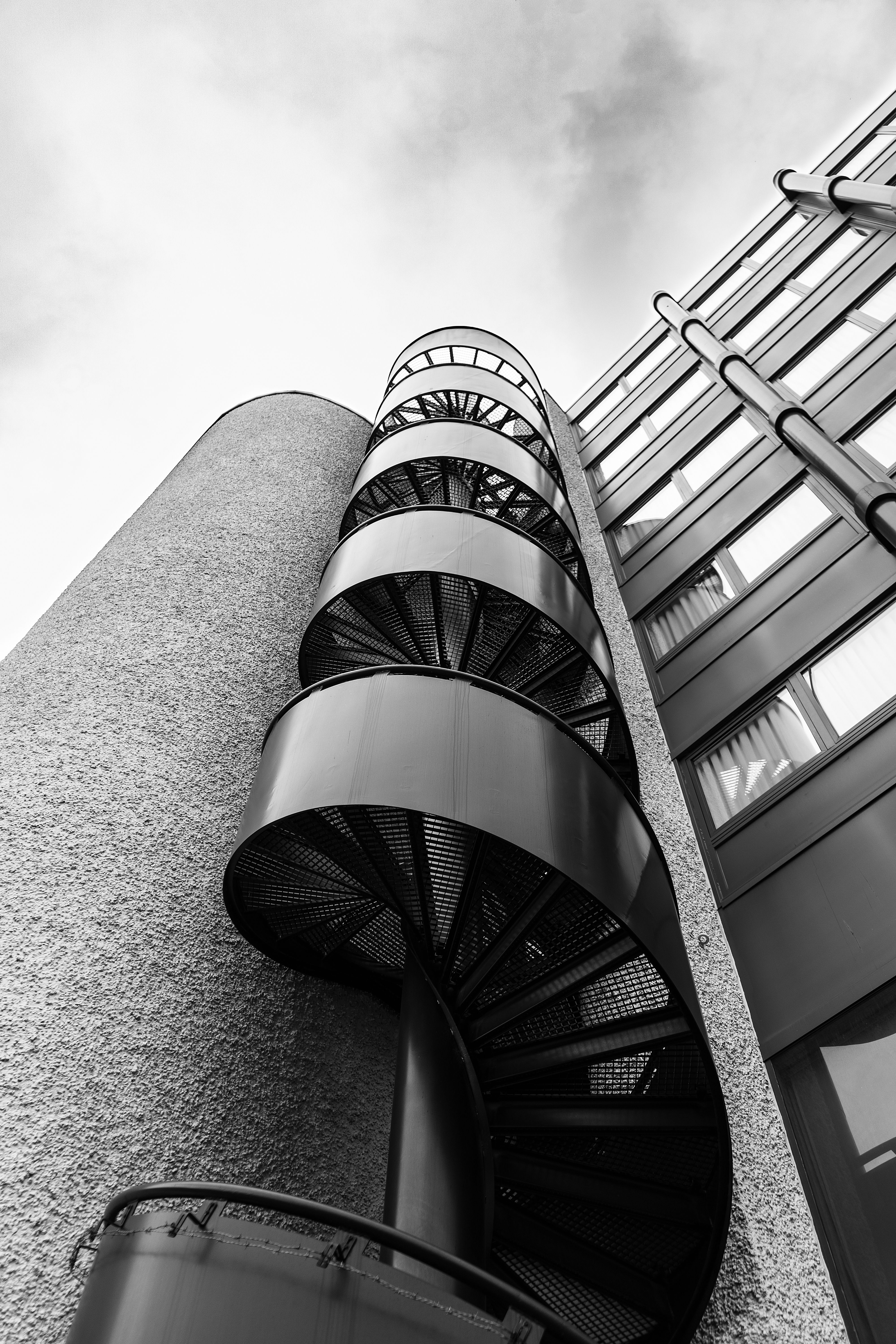 Monochrome spiral staircase in Aarau, Switzerland, showcasing modern architectural design.