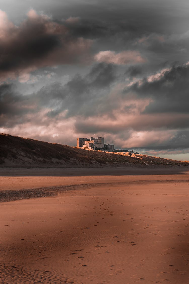 Castle Built On Sea Shore Under Cloudy Sky