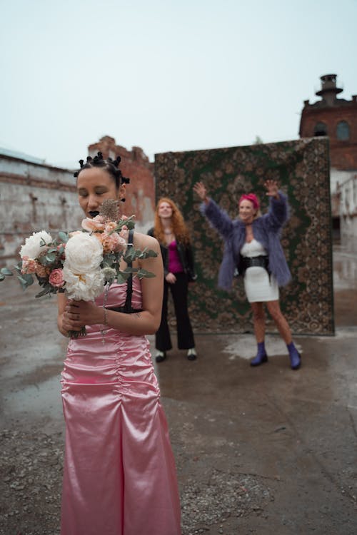 Woman in Pink Dress Standing with Flowers