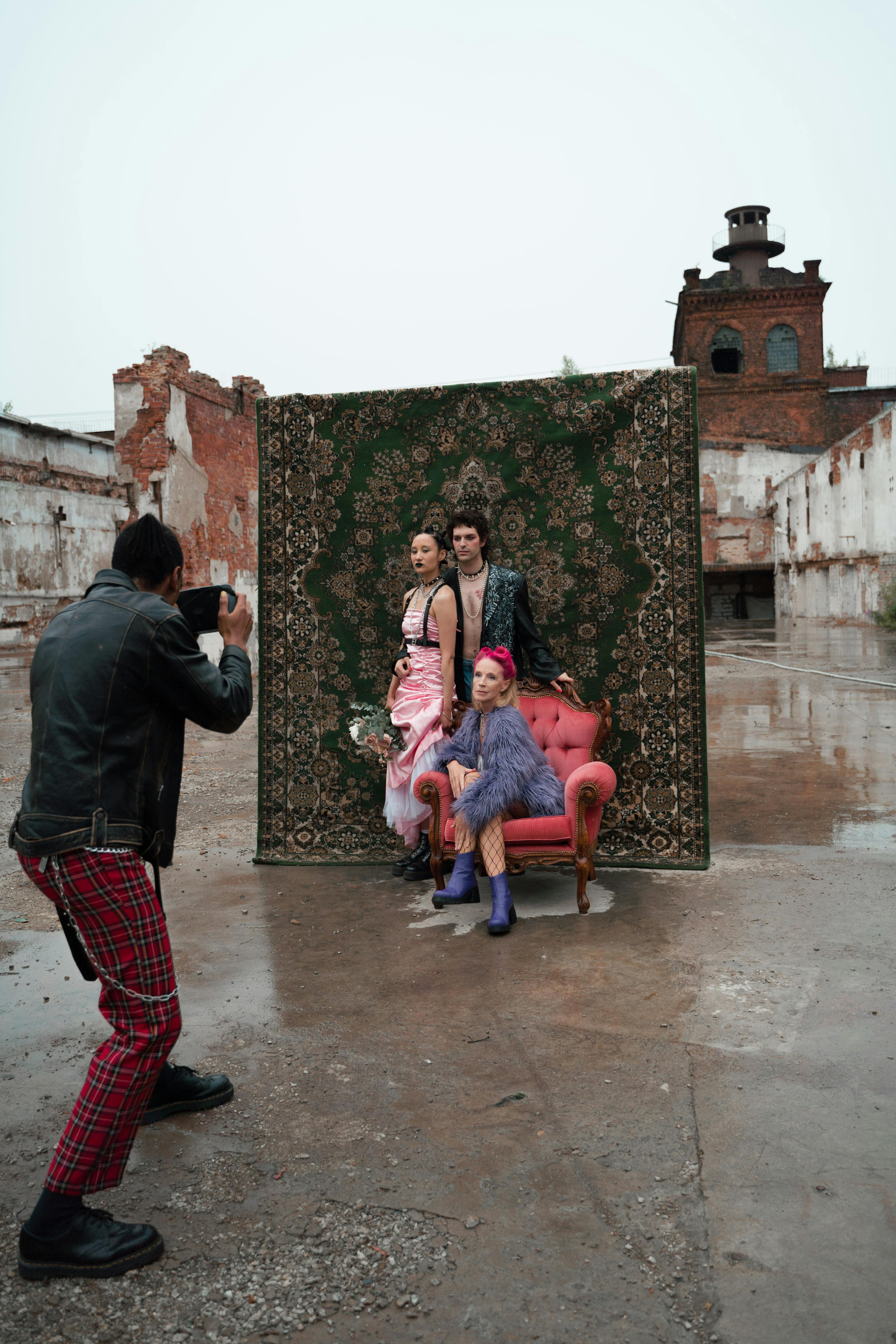 Photographer Taking Pictures of Women and Man with Carpet behind · Free  Stock Photo