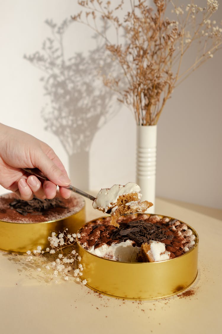 A Person Eating A Cake