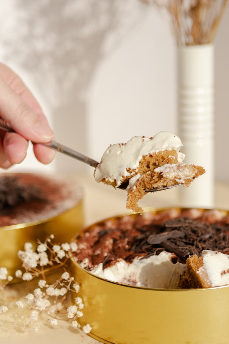 Close Up Of A Person Eating A Cake