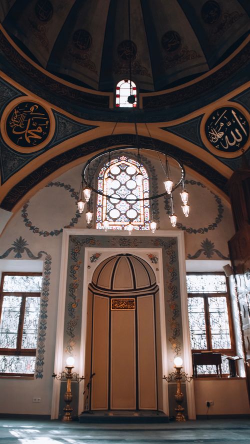 Free Beautiful interior of a mosque showcasing intricate Islamic architectural design and stained glass. Stock Photo