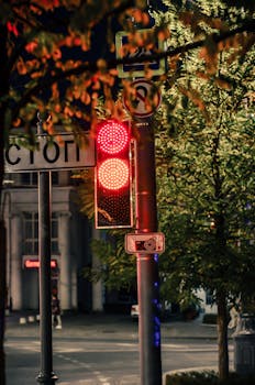 Traffic light on a nighttime city street in Sevastopol, featuring vibrant red signals.