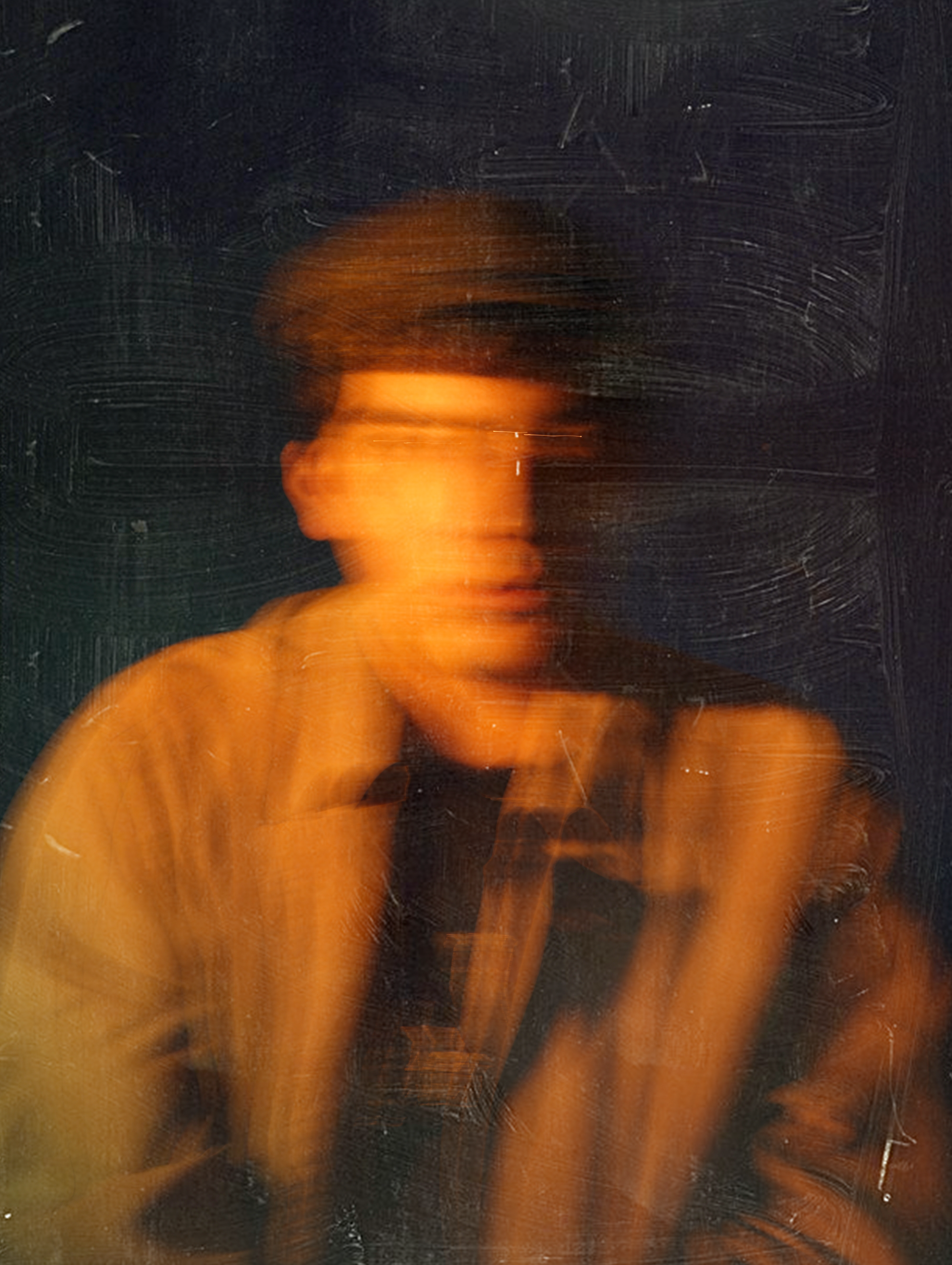 Artistic blurred portrait of a man wearing a hat and jacket, highlighting creativity and motion.