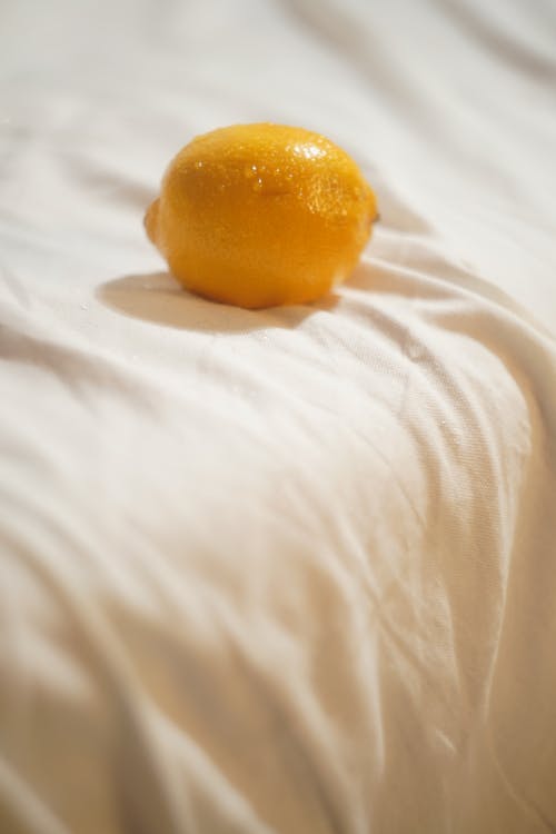 Free Yellow Lemon on White Textile Stock Photo