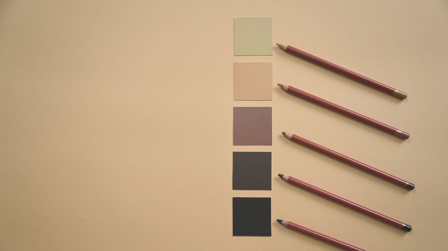 Flat lay of colored pencils and earthy tone swatches on a beige background, perfect for art and design contexts.. pexels, fla