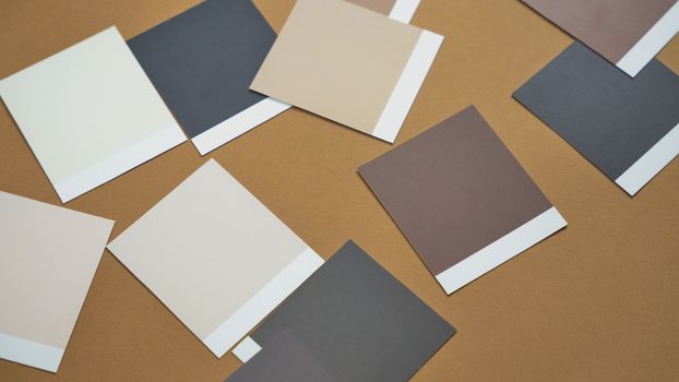An overhead shot of various color swatches on a brown surface, illustrating design choices.