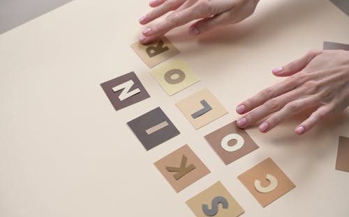 Person Spelling Skin Color on Letter Cut-outs