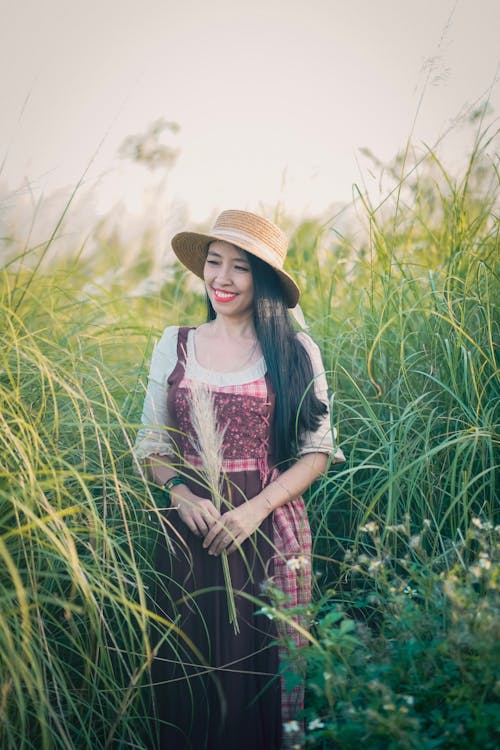 Photo of a Standing Smile Woman with Straw Hat · Free Stock Photo