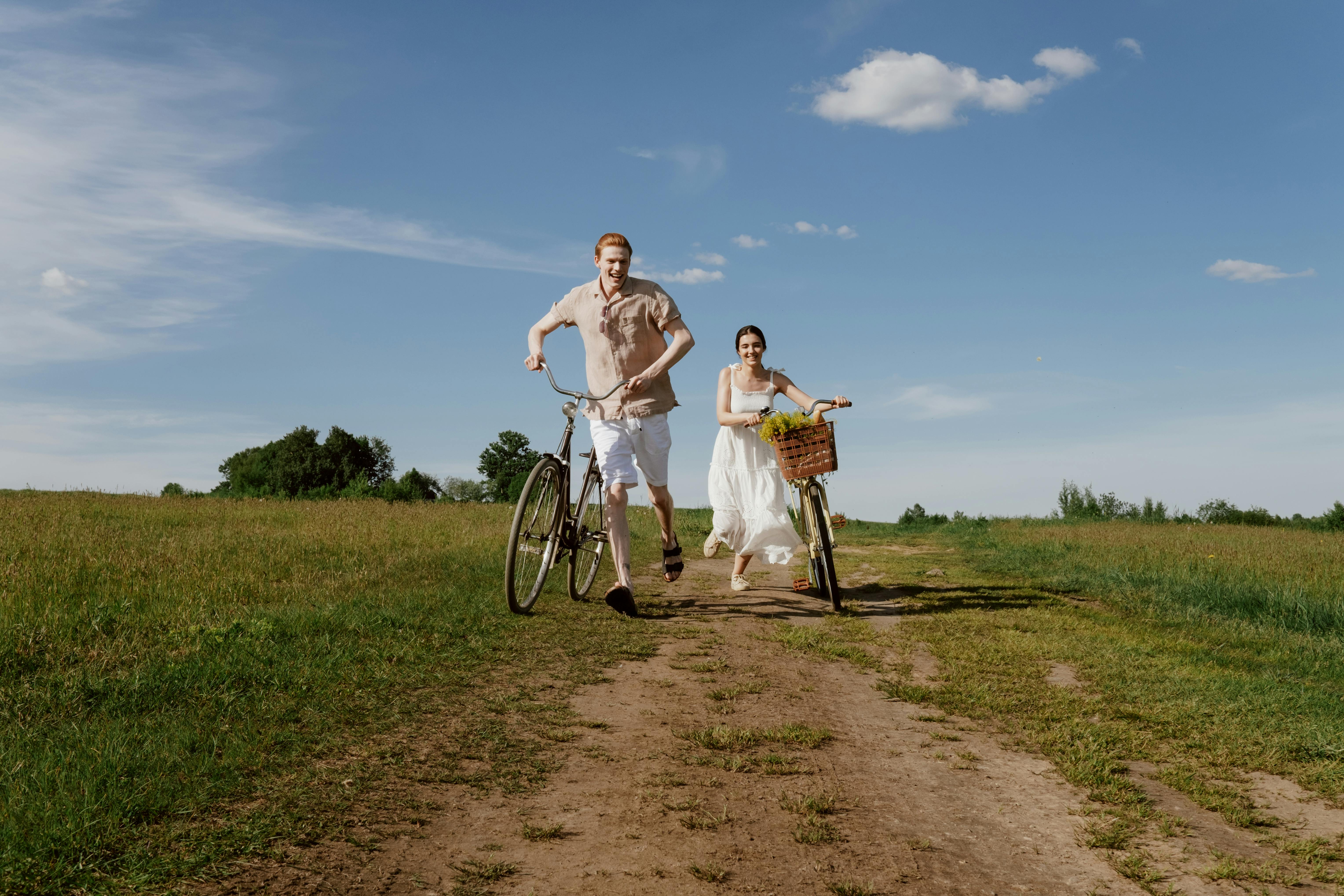 man and woman running with bicycles