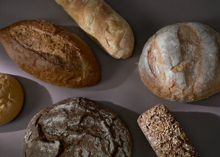 A Different Types Of Breads On A Flat Surface