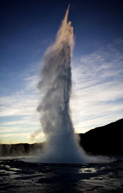 Free Stunning geyser eruption captured in Iceland with a clear blue sky backdrop. Stock Photo