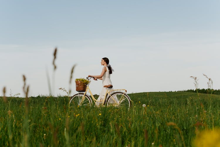 Girl Riding Bike On Field