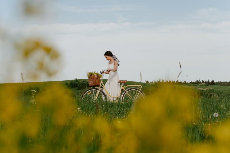 Girl Riding Bike On Meadow