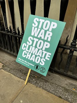 Image of a protest sign urging to stop war and climate chaos.