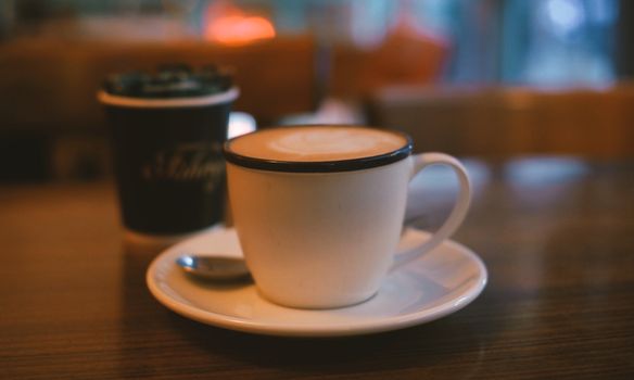 Warm coffee cup with latte art on a table in a cozy Istanbul cafe, creating a relaxing atmosphere.