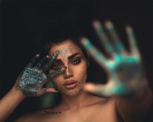 Free A Woman with Glitters on Face and Hands Stock Photo