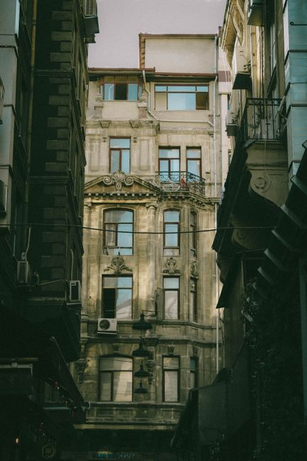 A view of classic European architecture seen from an urban alleyway with dramatic lighting.