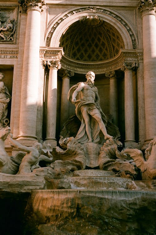 Free Statue on Trevi Fountain in Rome, Italy Stock Photo