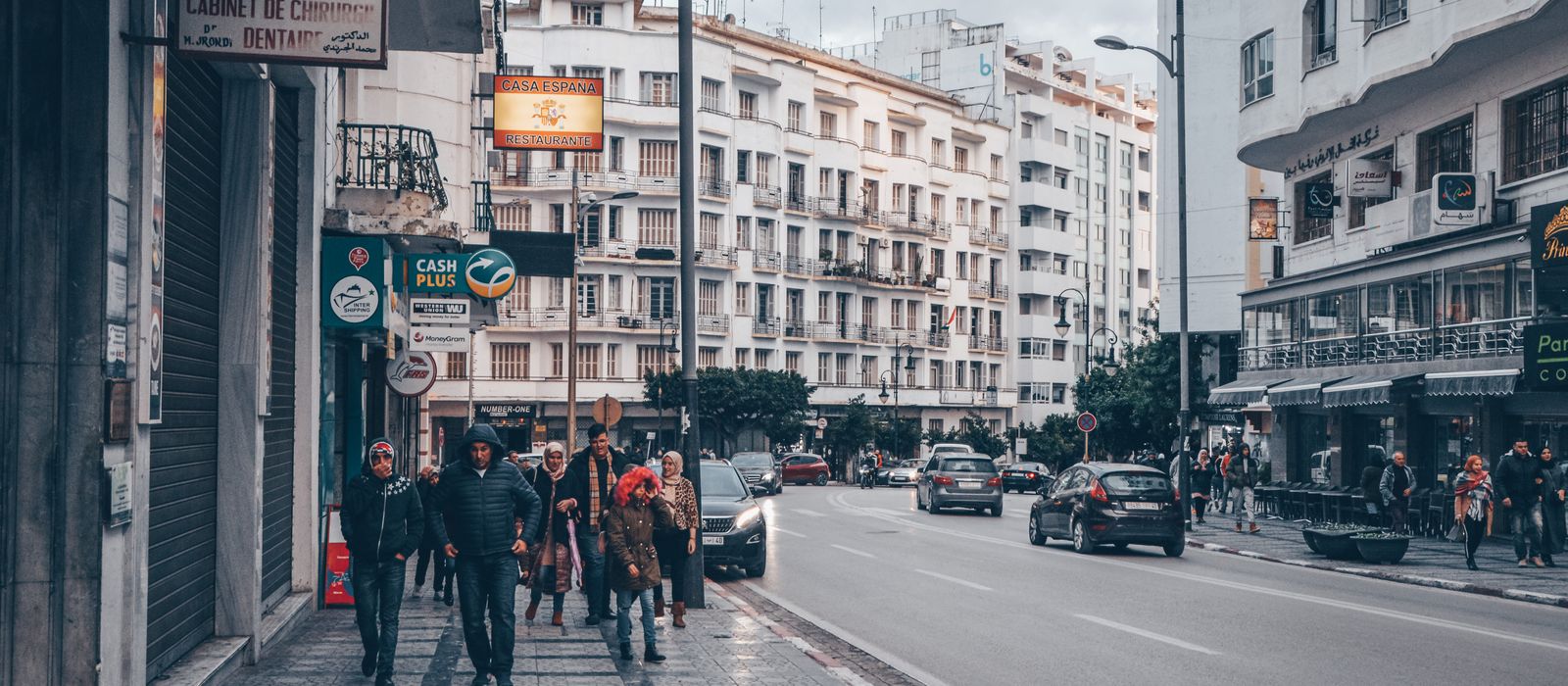 Vibrant street life in downtown Tangier, Morocco, showcasing people and cars on a busy road. — flights from Brussels to Tangier