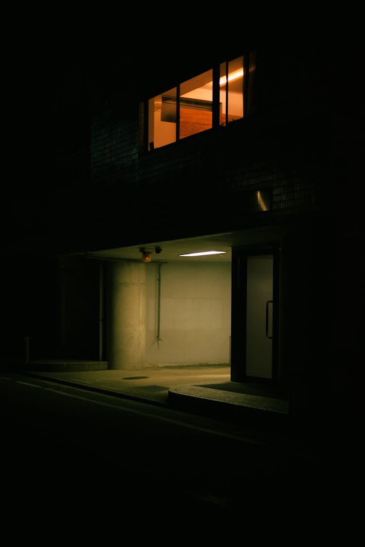 Apartment Building With Lights At Night Time