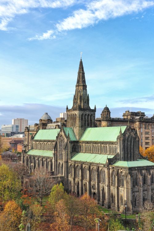 Free Stunning aerial view of historic Glasgow Cathedral with a beautiful blue sky backdrop. Stock Photo