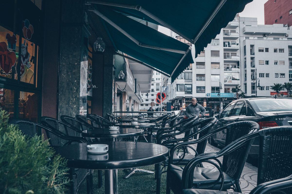 A café terrace in Tangier — the city's café culture, shaped by decades of literary and artistic exiles, remains central to daily life.