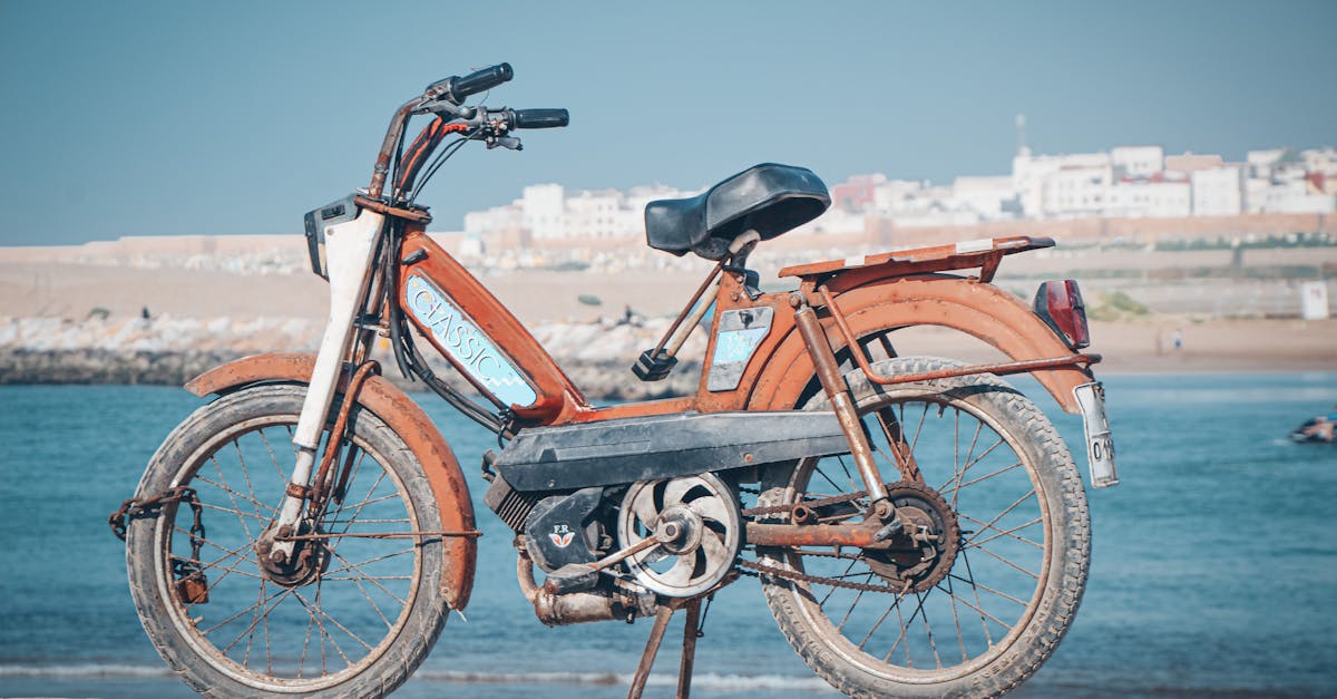Vintage Peugeot moped parked by the sea in Rabat, Morocco.