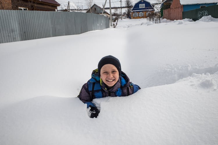 Young Boy Playing In Snow