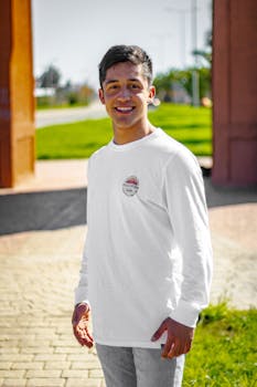 Portrait of a smiling young man standing outdoors in Chillán Viejo, Chile, on a sunny day.