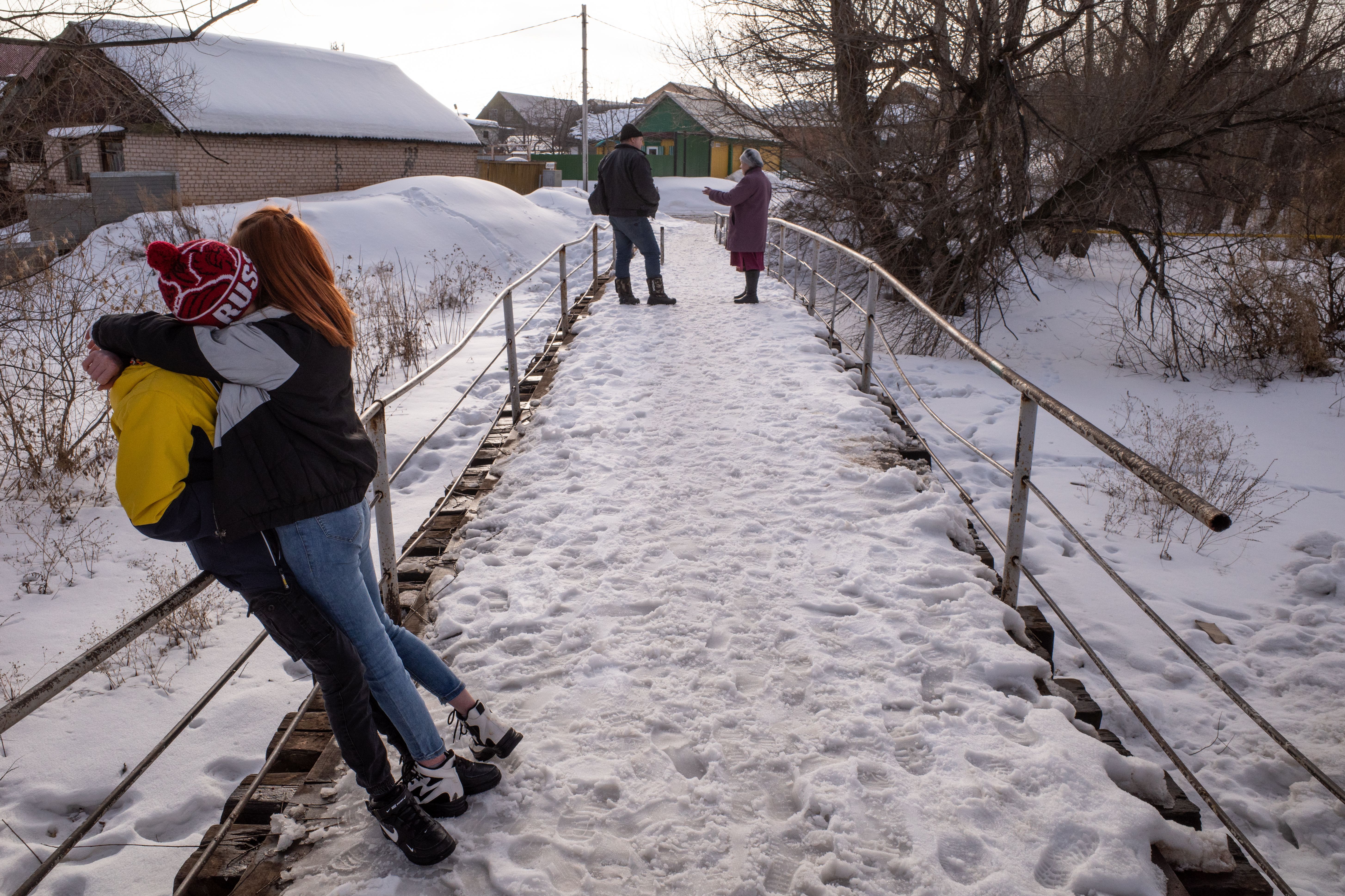 Couple Hugging on Snow Covered Bridge · Free Stock Photo