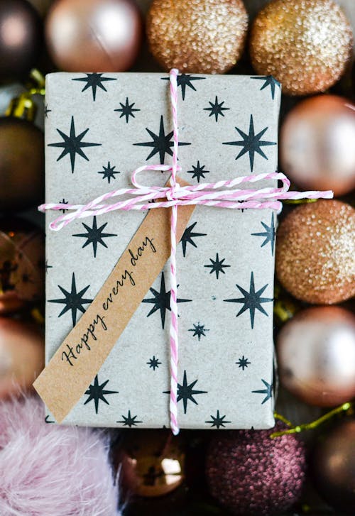 Gift Box With Ribbon Beside Christmas Balls 