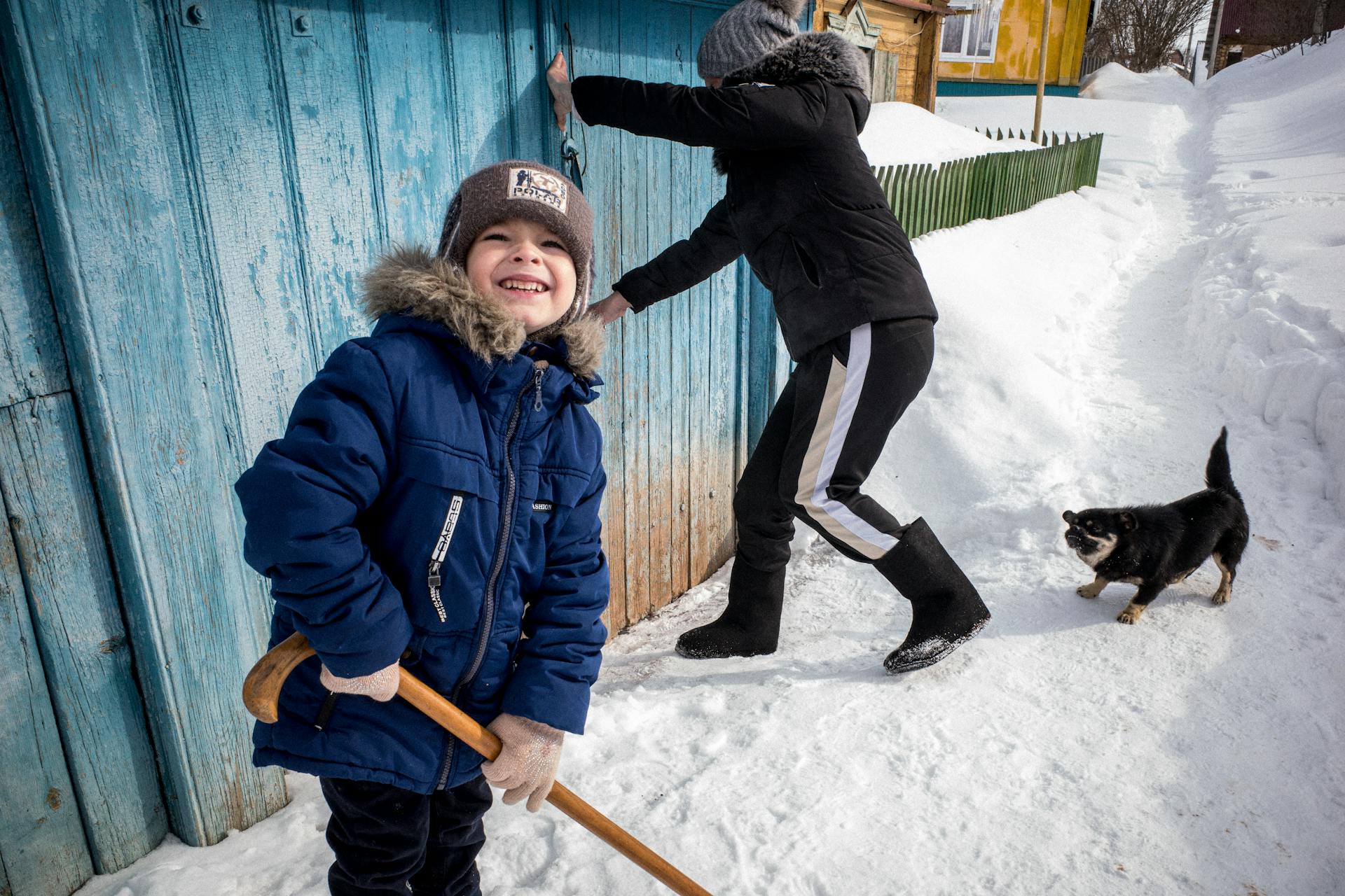 Children and Dog near Shed in Winter