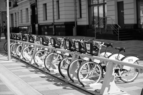 Free Black and white photo of bicycles parked in a city bike rack, showcasing urban life. Stock Photo