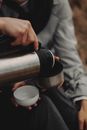A Person Pouring a Drink for a Thermos