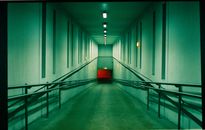 Empty Hallway With Red and White Metal Railings
