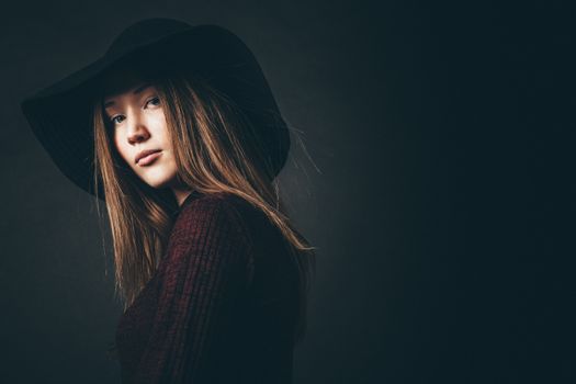 A Young Female Looking at Camera and Wearing a Hat 