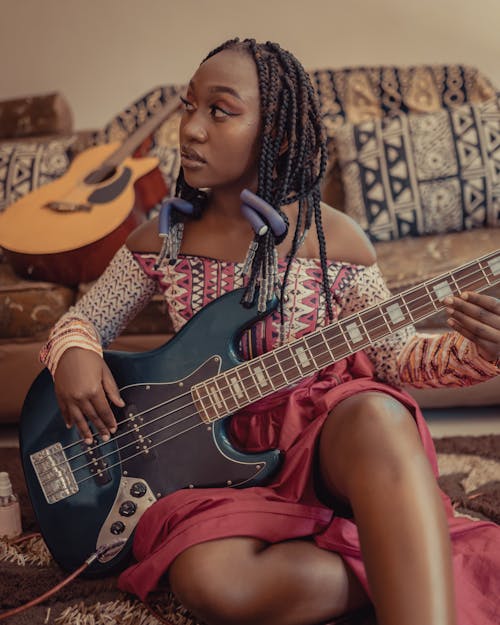 Woman with Braided Hair Playing Bass Guitar