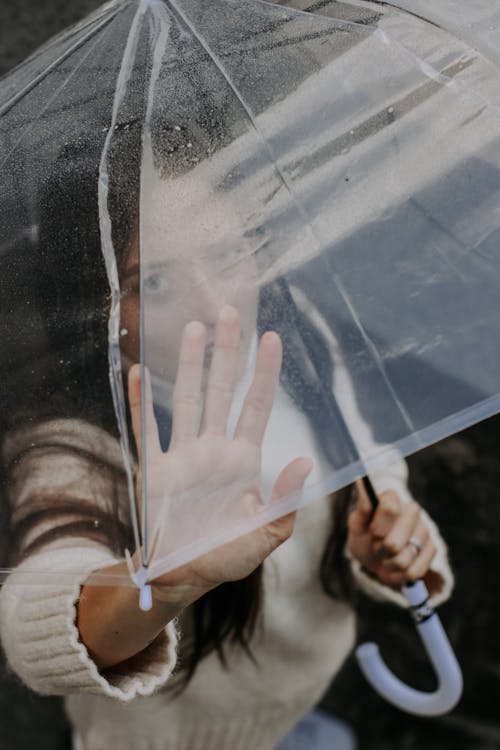 Woman Looking through Umbrella
