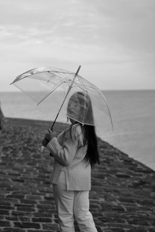 Grayscale Photo of Woman Holding an Umbrella