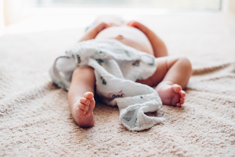 Adorable Newborn Baby Lying Down Sleeping On Bed